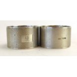 A pair of silver engine turned napkin rings, maker (?)FH, Sheffield 1944,