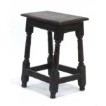 An 18th century and later oak joint stool on turned supports joined by cross stretchers