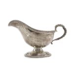 A silver sauce boat of typical form with gadrooned handle and borders, maker R&B, Sheffield 1974,