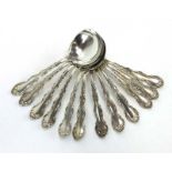 A set of twelve Continental silver dessert spoons with foliate decoration,