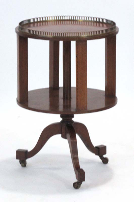 An Edwardian mahogany and strung two-tier drum table on three splayed legs, d.