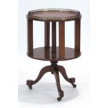 An Edwardian mahogany and strung two-tier drum table on three splayed legs, d.