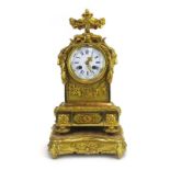 A late 19th century French mantle clock, the enamelled face with Roman and Arabic numerals,