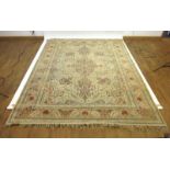 A 20th century woolen rug decorated with floral patterns within matching borders,