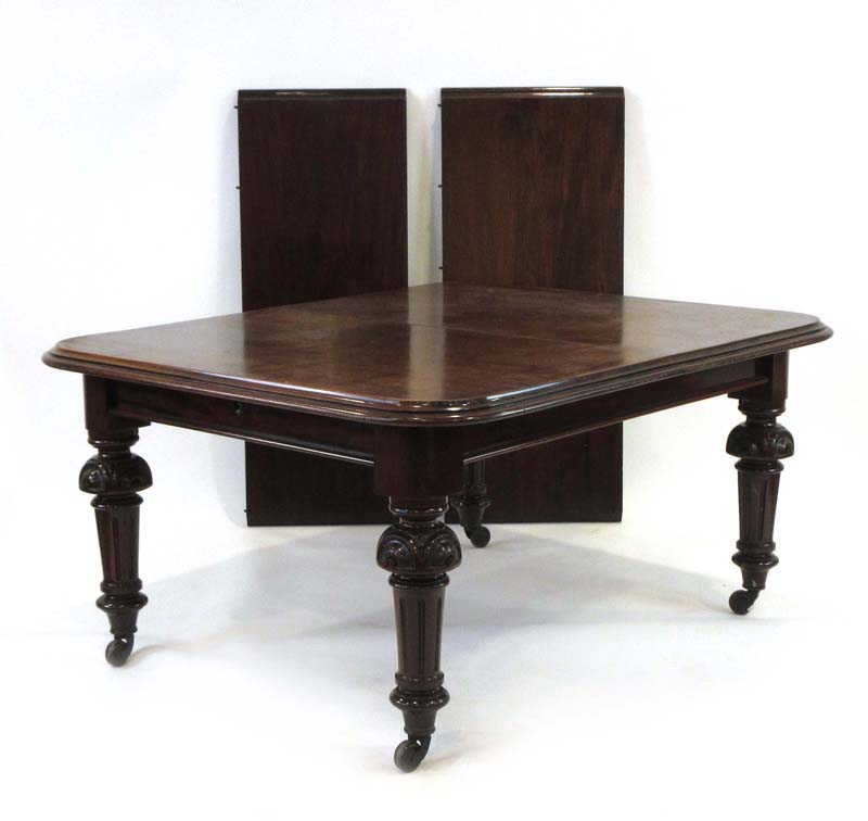 A 19th century mahogany extending dining table with two fitted leaves on turned legs with castors, - Image 2 of 2