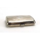 An early 20th century silver and parcel gilt cigarette case of cushioned rectangular form,