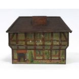 An early 20th century Hudson Scott money box in the form of a Tudor house