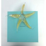 Elsa Peretti for Tiffany, a clear and gilt glass ornament in the form of a starfish, w.