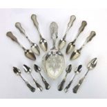 A pair of Dutch pierced metalware serving spoons, together with twelve similar teaspoons, overall 5.