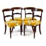 A set of four 19th century rosewood and brass inlaid dining chairs with scrolled back rails over