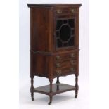 A Victorian rosewood music cabinet with an arrangement of four drawers and one astragal glazed door,