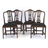 A set of four Georgian mahogany dining chairs with drop-in seats and square tapering legs