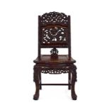 A 19th century Chinese Export carved rosewood hall chair with a shaped front and carved legs