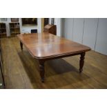 A late 19th century mahogany extending dining table, with three fitted leaves,