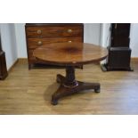 A 19th century rosewood centre table, the circular tilt-top on a turned column, d.