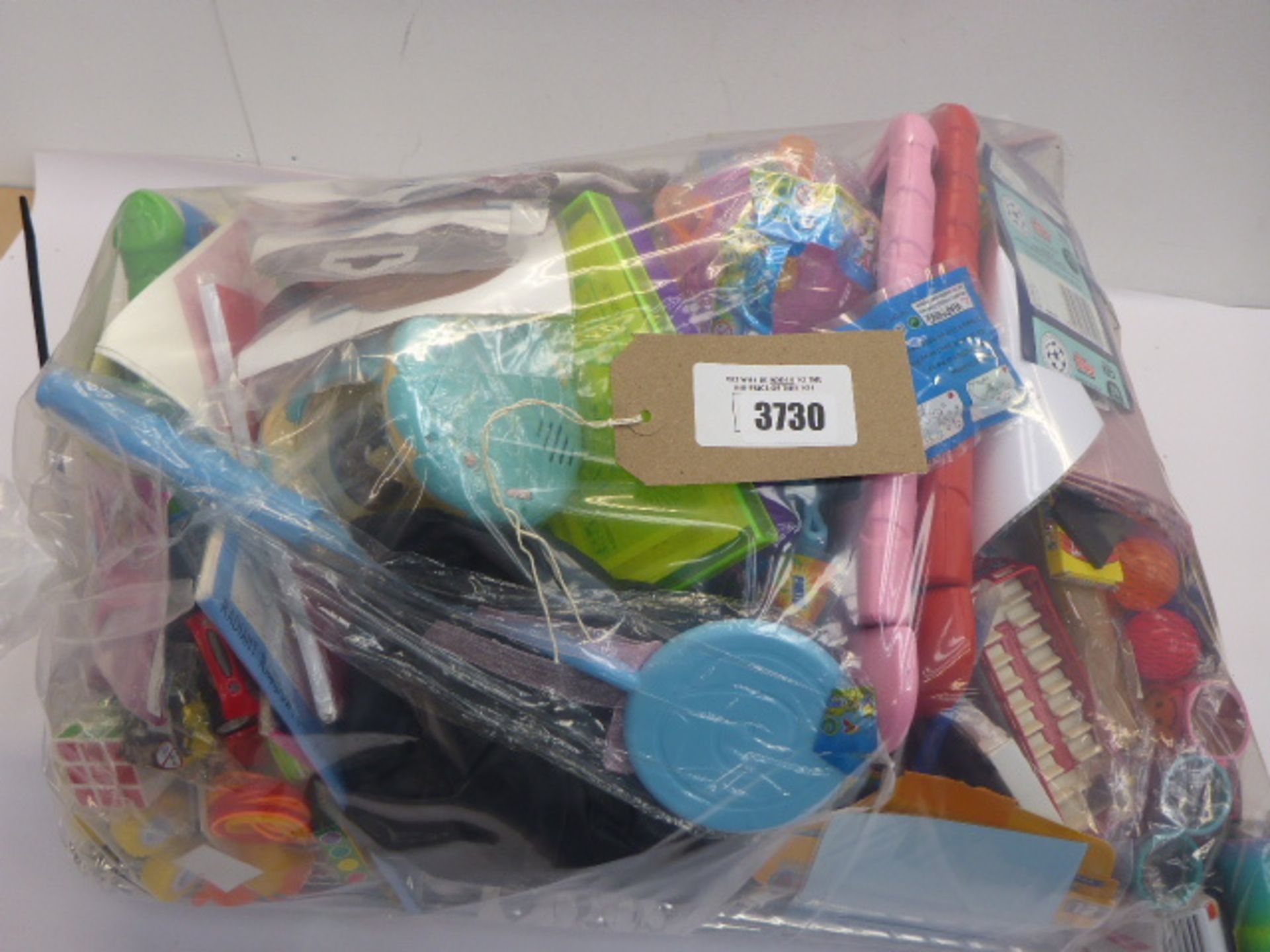 Large bag of novelty toys including Trading cards, bouncy balls, iPad covers, Hot Wheel cars,
