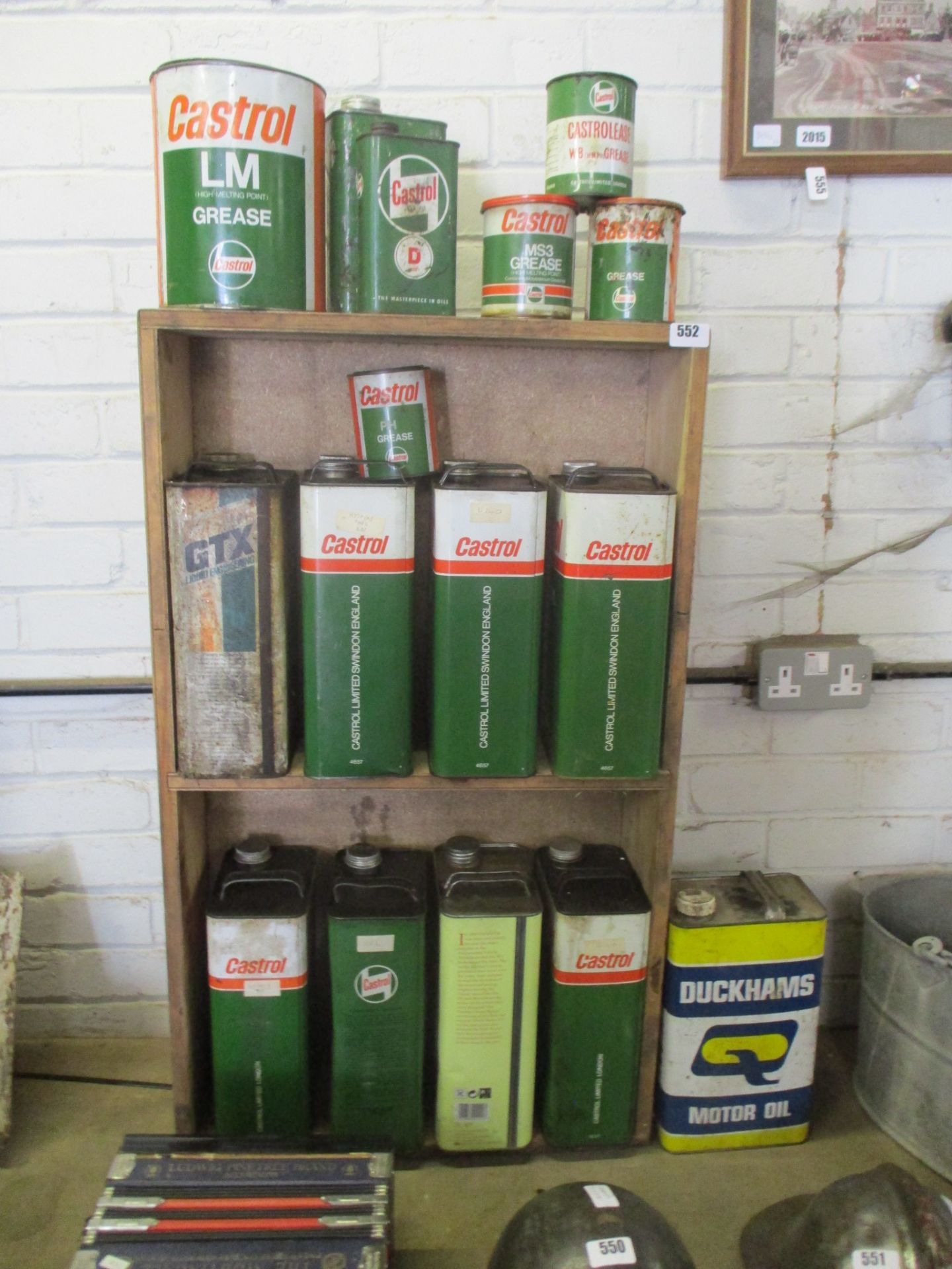 Rack and contents of mainly Castrol motor oil and grease