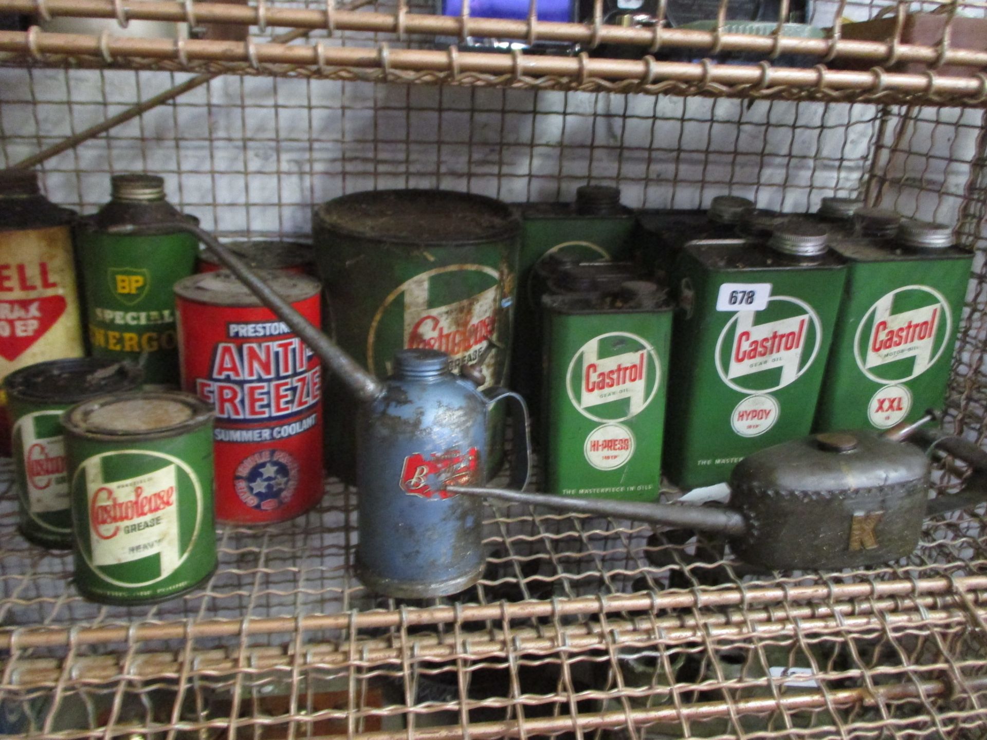 Half shelf of BP, Shell and Castrol oil cans with 2 other vintage oil cans