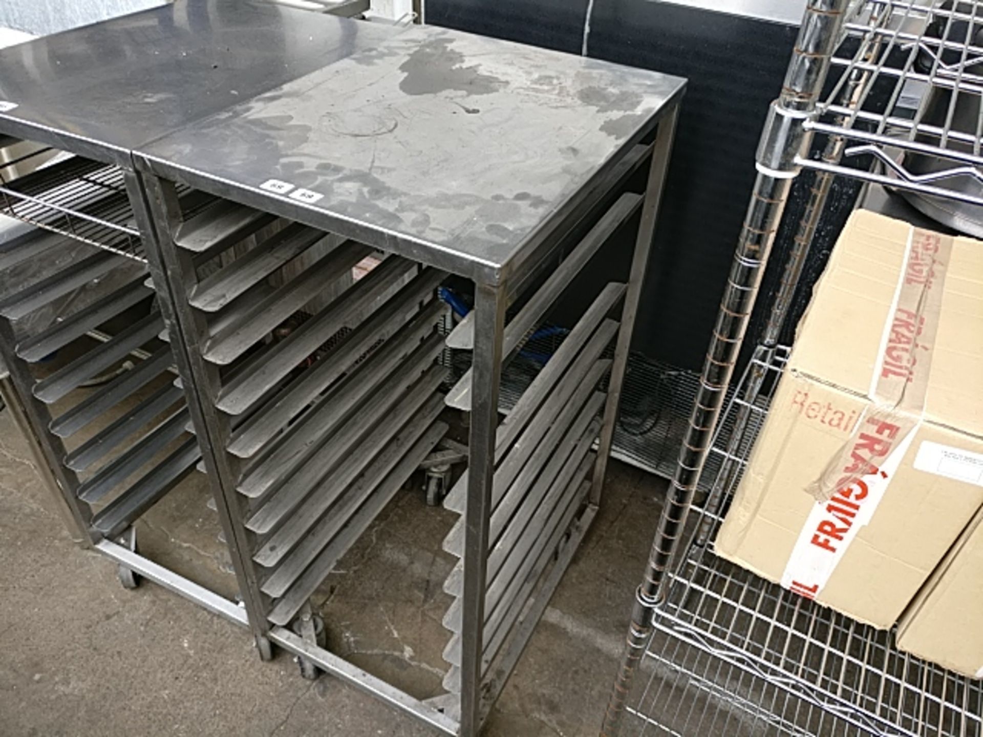 (69) A mobile bakers rack with shelves 47cm by 65cm with no trays