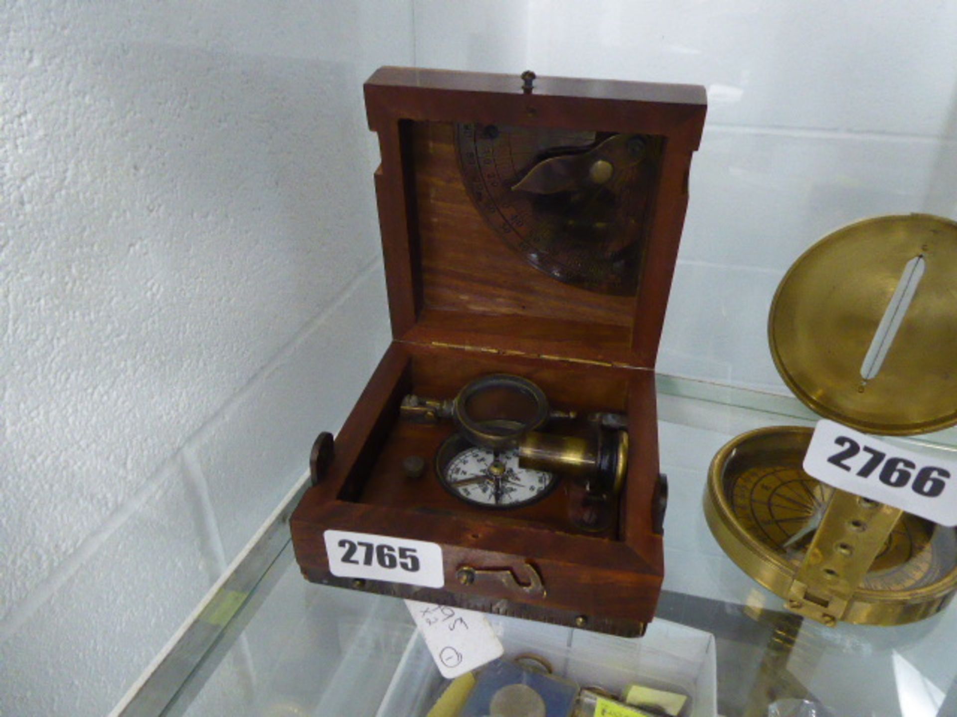 Wooden box containing compass and accessories.