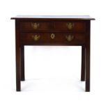 A George III oak side table with an arrangement of three drawers on canted legs, w.