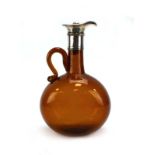 An early 20th century brown glass jug of slender globular form with metalware mount and silver