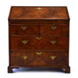 A Georgian walnut and feather crossbanded bureau, the fall front enclosing a fitted interior,