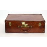 A 1920's Louis Vuitton tan leather suitcase with brass fittings,