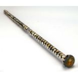 A walking cane constructed of shell pieces,
