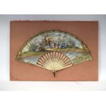 An early 19th century French fan, the bone sticks supporting a painted classical scene,