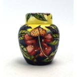 A modern Moorcroft ginger jar and cover decorated with hibiscus on a yellow ground, h.