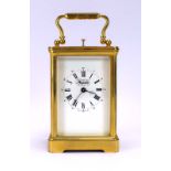 A 20th century carriage clock, the face with Roman and Arabic numerals,