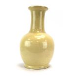 A Chinese bottle vase decorated in a plain cream glaze, h.
