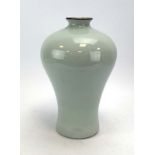 A modern Chinese stoneware vase of shouldered form decorated in a plain celadon glaze,