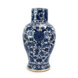 A Chinese blue and white vase of baluster form decorated with foliate scrolls, h.