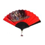 A late 19th/early 20th century hand fan with ebony sticks and hand painted with a domestic scene,