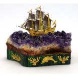 William Tolliday, a model of a three-master sailing ship over a mineral sea, on a matching plinth,