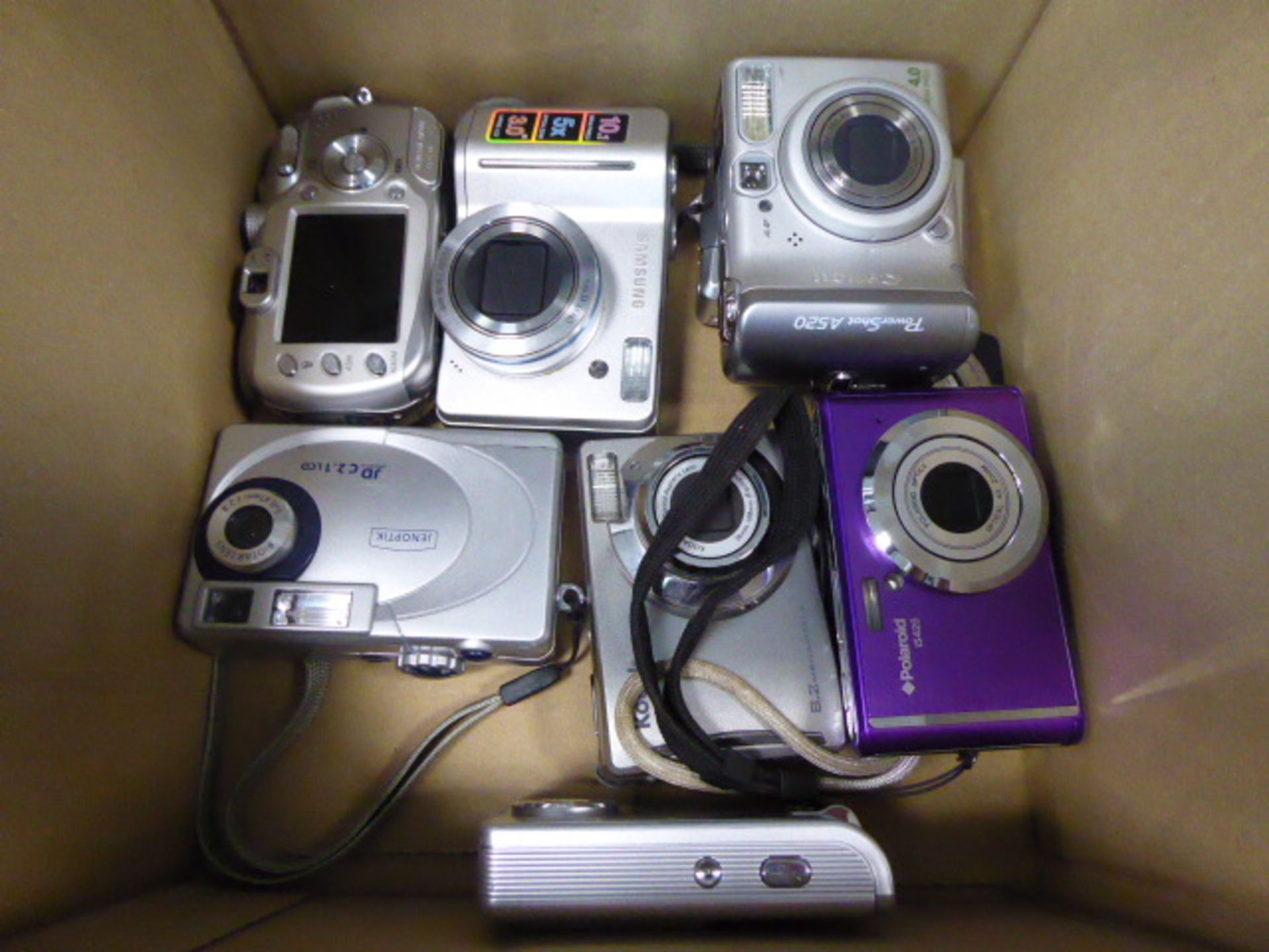Box comprising approximately 9 digital cameras as found