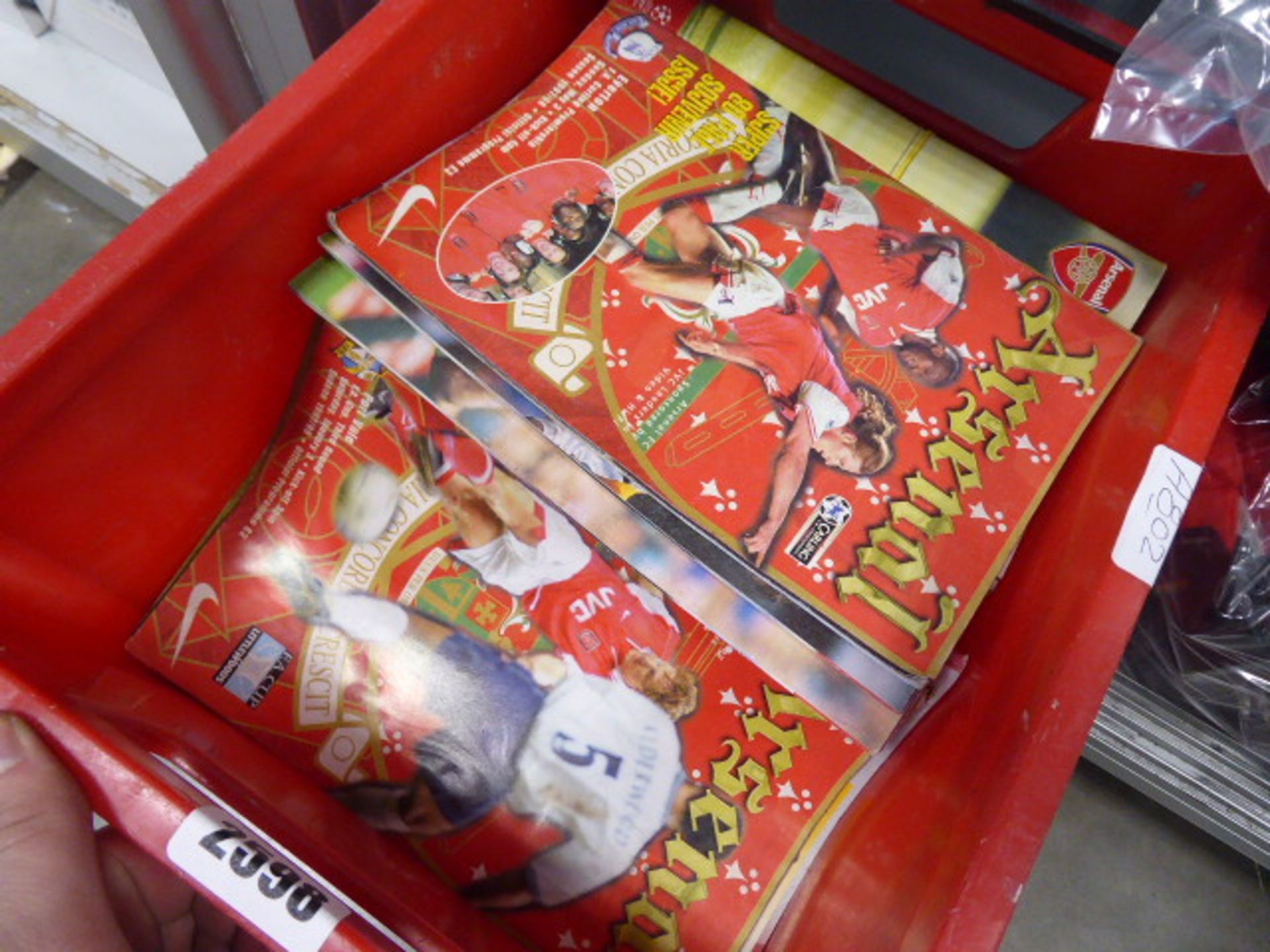 Box containing selection of Arsenal match day programmes