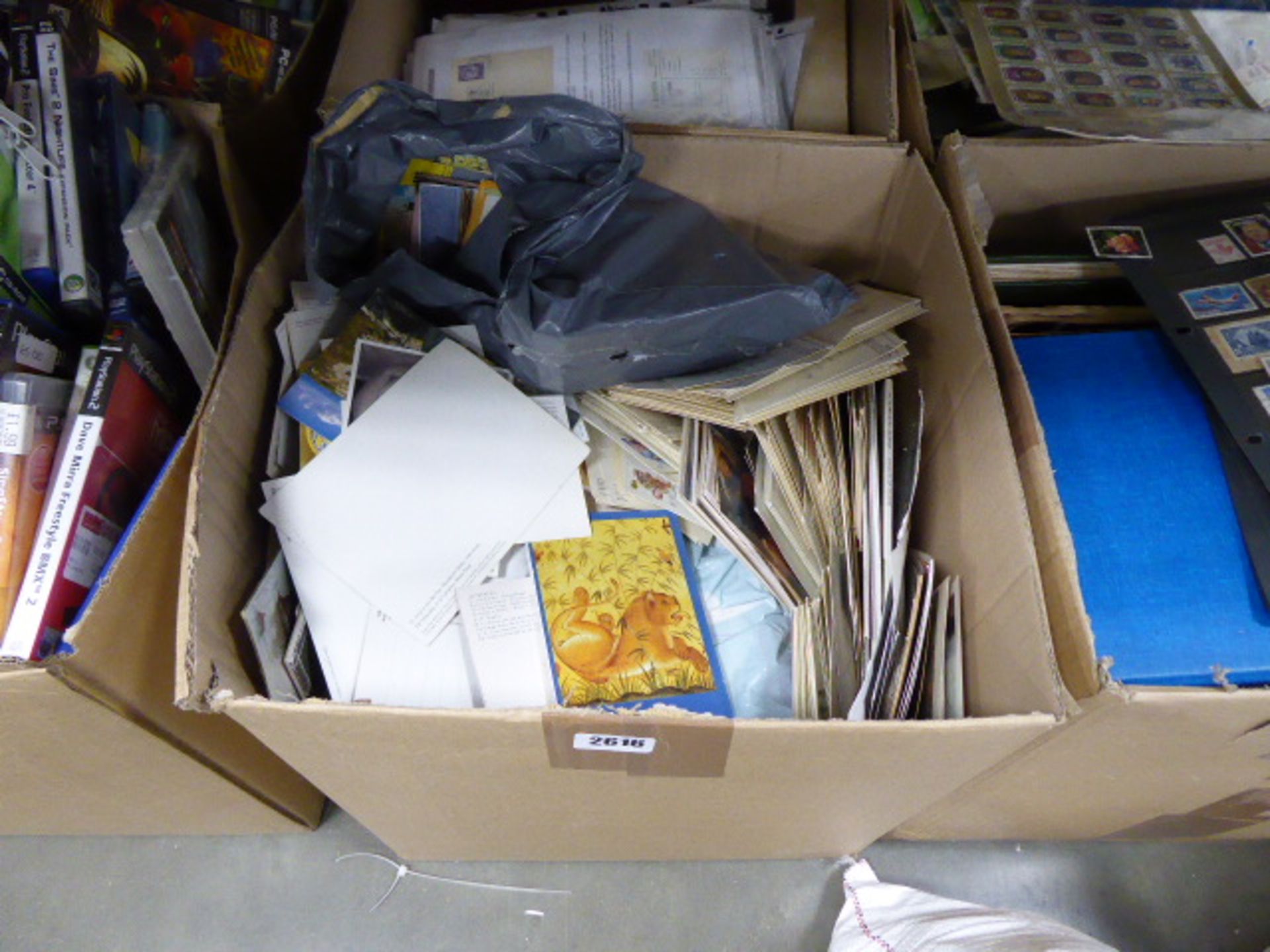 4 boxes containing large quantity of various postage stamp albums and postcards