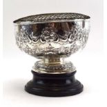 An Edwardian silver rose bowl of typical form repousse decorated and chased with foliate scrolls on