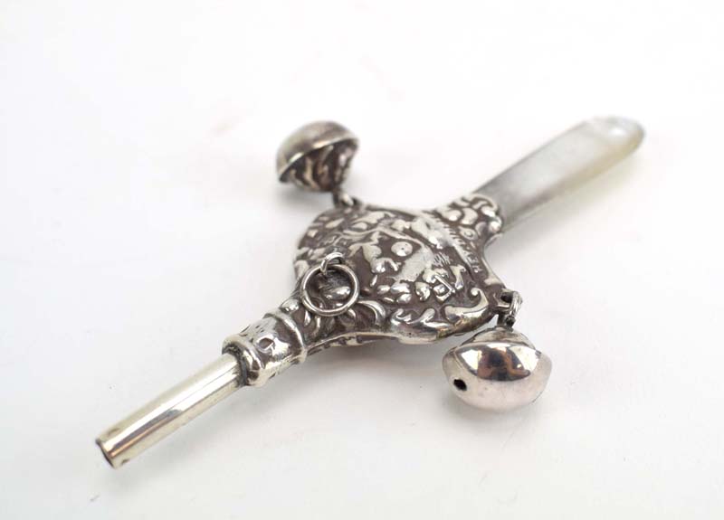 A late Victorian silver rattle with mother of pearl teether,