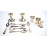 A mixed parcel of silver comprising a pair of dwarf candlesticks, six demitasse spoons,