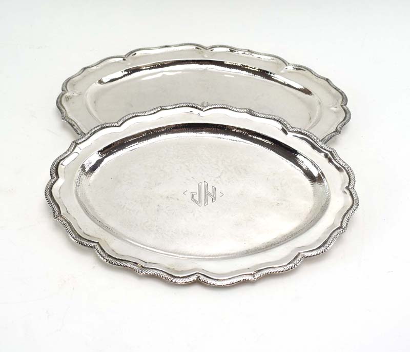 A graduated pair of (?)South American silver serving dishes of oval flowerhead form,