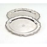 A graduated pair of (?)South American silver serving dishes of oval flowerhead form,