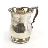A silver Christening mug of typical form with leaf capped c-scroll handle,