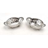 A pair of small pierced silver dishes, each of pinched oval form on four ball feet, Tiffany & Co.