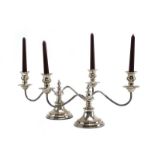 A pair of mid-20th century silver two branch candlesticks of elongated form, maker EV,