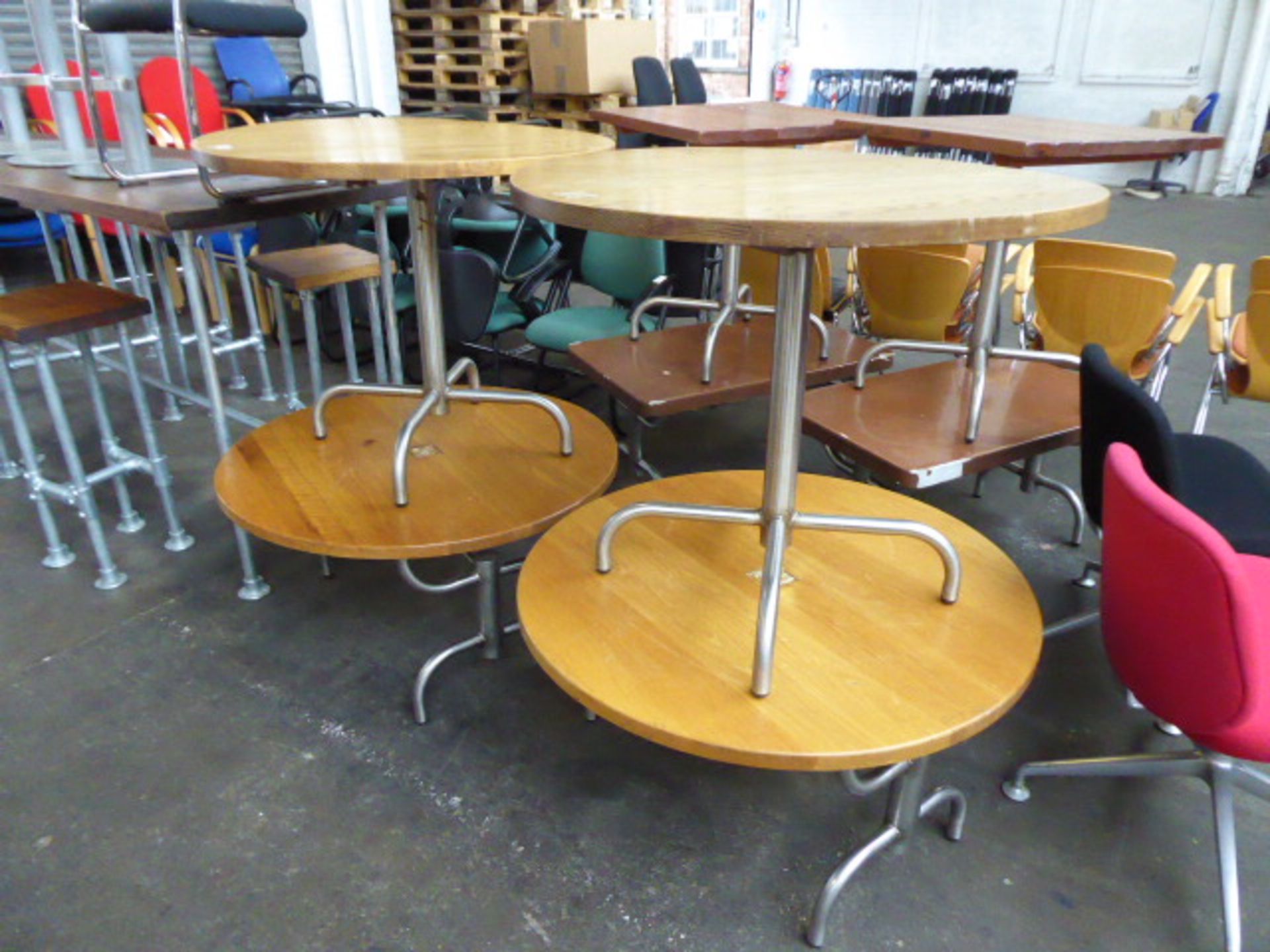 Set of eight industrial design metal framed tables to include two circular top dining tables, two