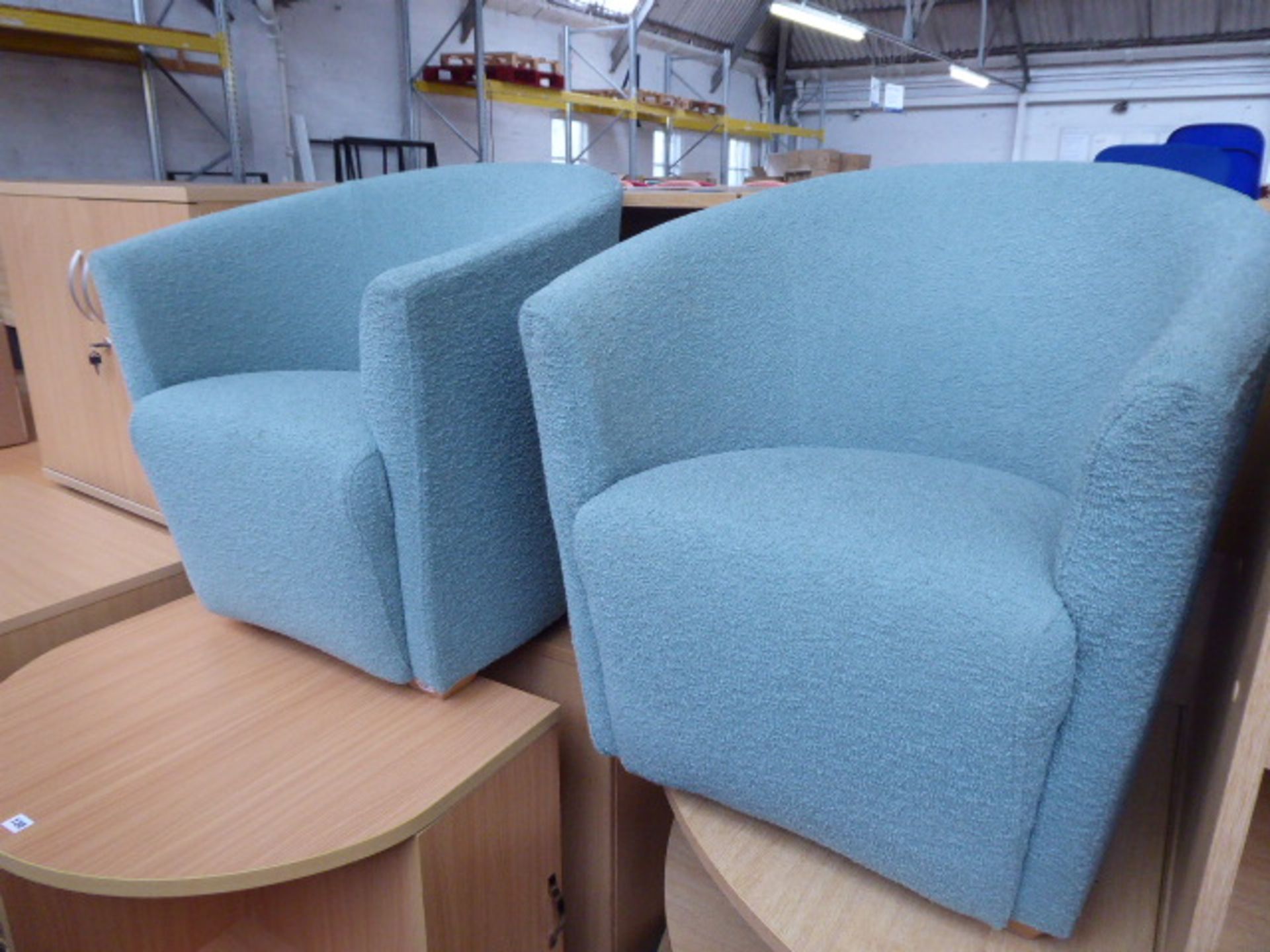 A pair of green cloth tubchairs